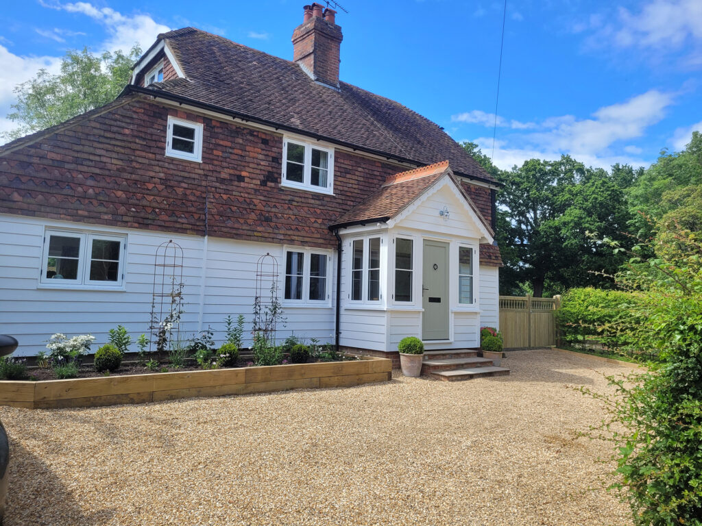 Deerwood Construction exterior whole-house refurbishment showing updated cottage frontage in Crowborough East Sussex.