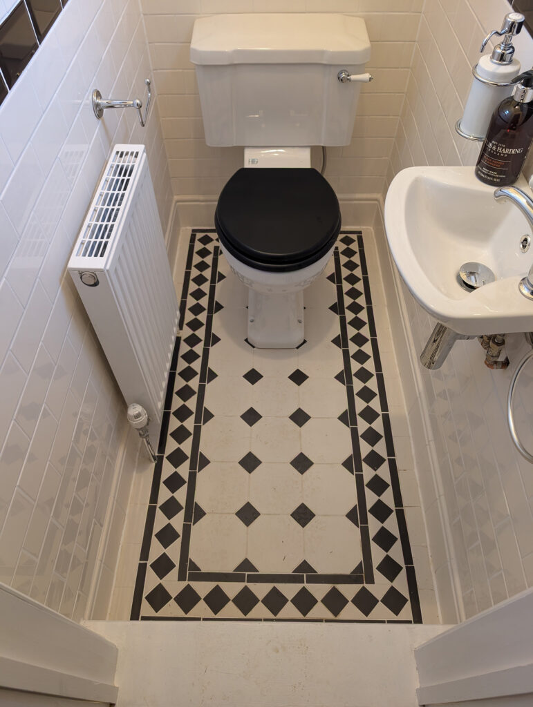 Deerwood Construction restored WC with Victorian style floor tiles in whole-house refurbishment in Crowborough East Sussex.