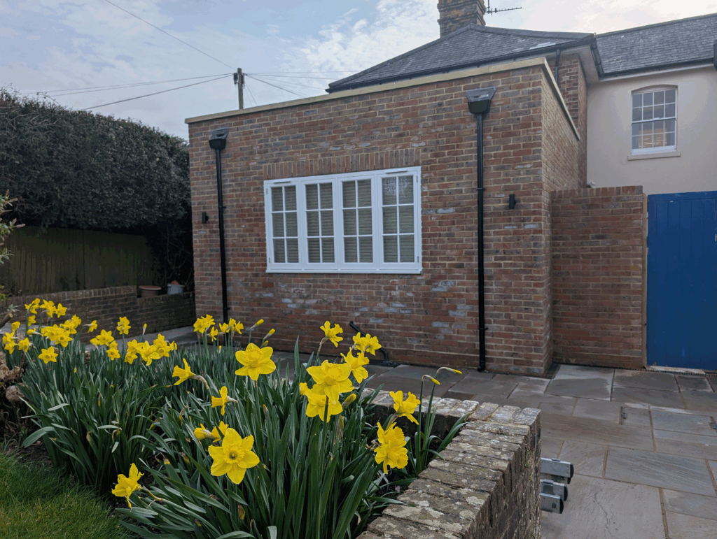 Deerwood Construction home extension in Crowborough East Sussex featuring brickwork and patio garden design.