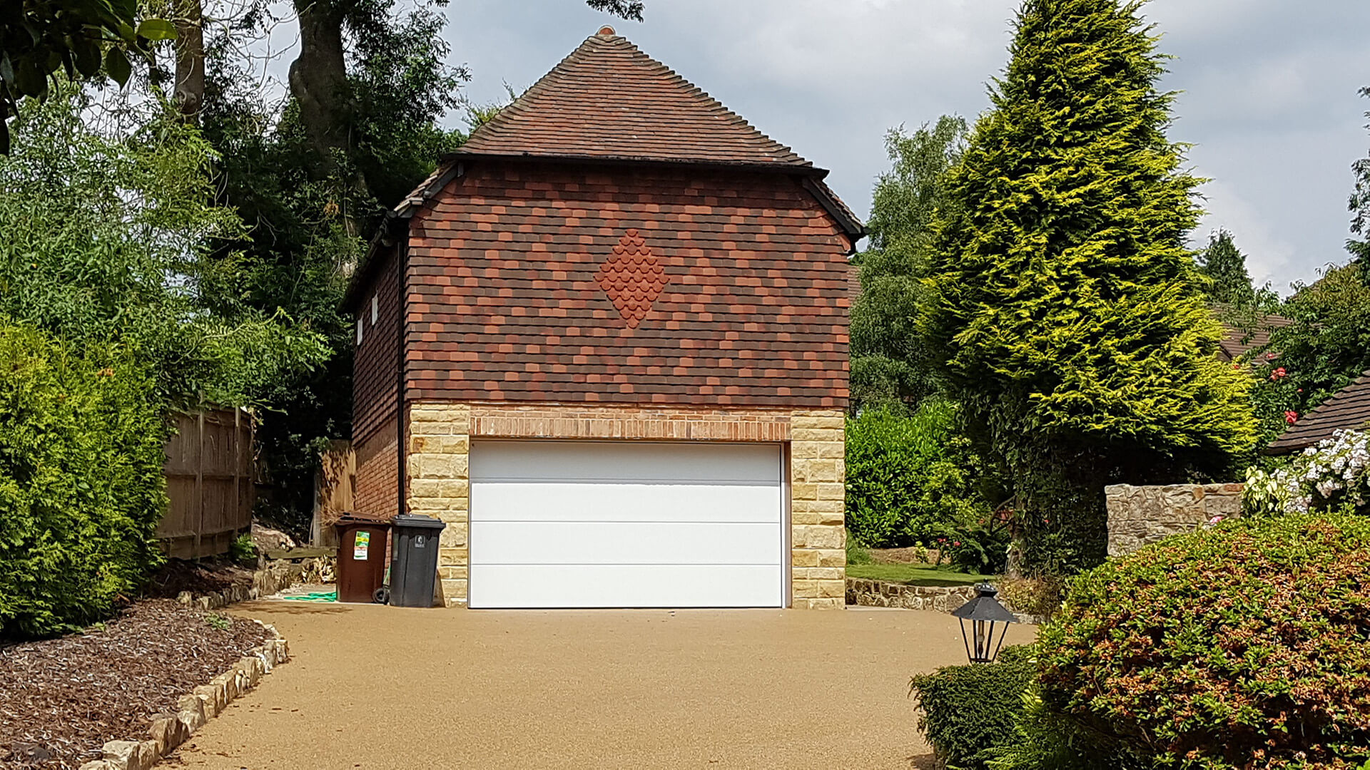 Garage conversion by Deerwood Construction in Crowborough East Sussex featuring brickwork, tiled roof, and new door installation.
