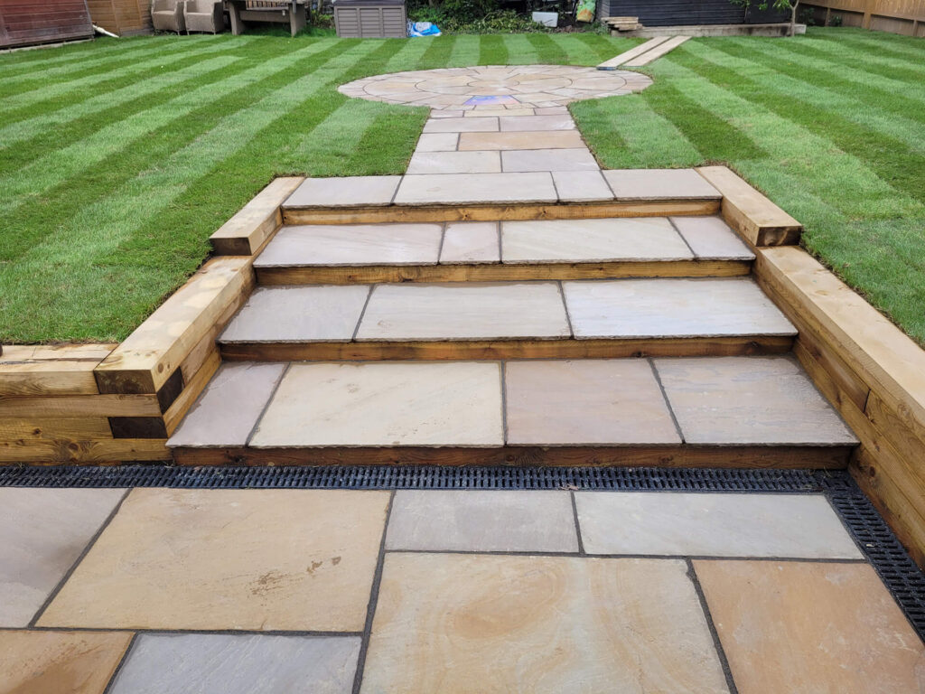 Landscaped garden with stone steps and lawn built by Deerwood Construction in Crowborough East Sussex for outdoor structuring projects.