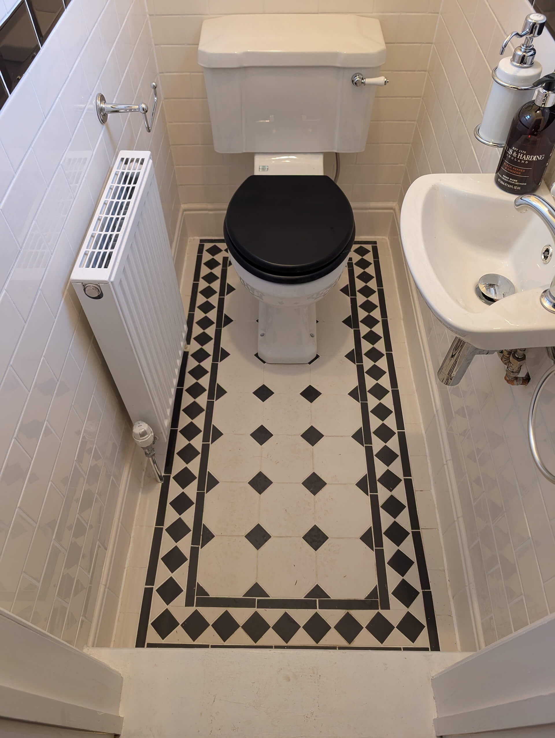 Bathroom renovation by Deerwood Construction in Crowborough East Sussex featuring patterned floor tiles and modern fittings.