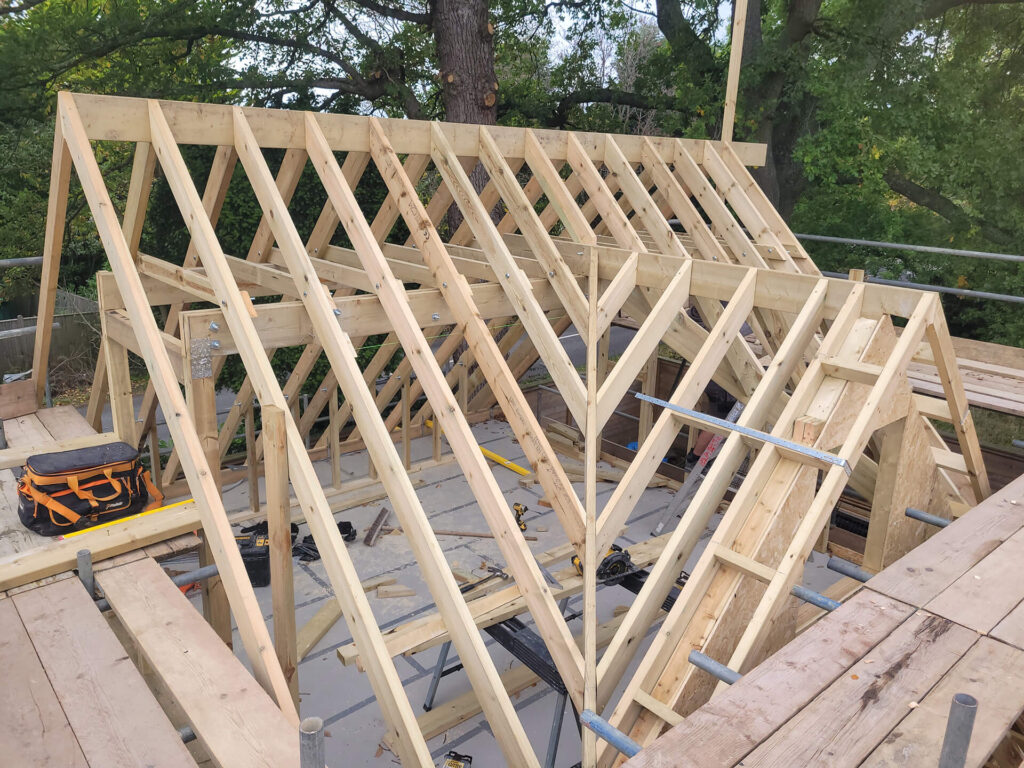Heritage-sensitive roof restoration by Deerwood Construction in Crowborough East Sussex featuring timber framework under repair.